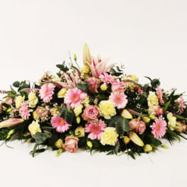Long floral spray with pink and yellow blooms on a white background