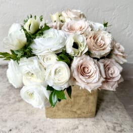 Bouquet of white and blush roses in a square box