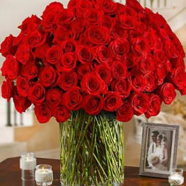 Large bouquet of red roses in a clear glass vase