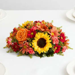Bright mixed bouquet with sunflowers, orange roses, and red daisies