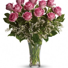 Pink roses arranged in a clear glass vase