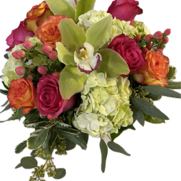 Colorful arrangement of hot pink roses, orange roses, green hydrangeas, and a green orchid