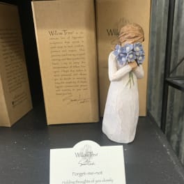 Small Willow Tree figurine holding blue flowers, displayed with its box