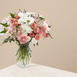 Pink and white mixed bouquet in a clear glass vase
