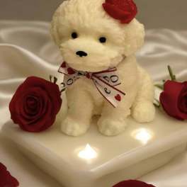 Plush white puppy with red roses on a lit white base