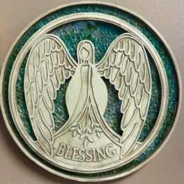 Round angel medallion with the word Blessing on a blue-green background