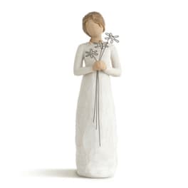 White figurine holding three wire flowers