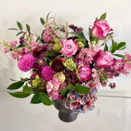 Pink and burgundy mixed bouquet in a dark vase