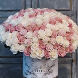 Large dome of pink and white roses in a marble-print box