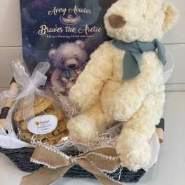 Gift basket with a teddy bear, cookies, and a children's book