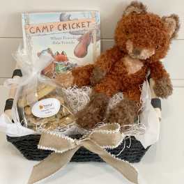 Gift basket with a teddy bear, cookies, and a book