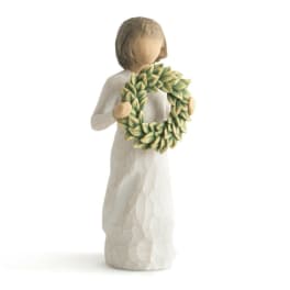 Figurine of an angel holding a green leaf wreath