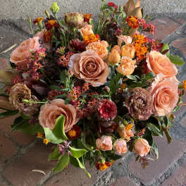 Peach and orange mixed bouquet with roses and small accent flowers