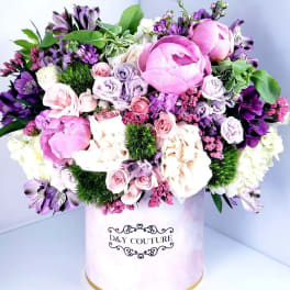 Pink and purple mixed bouquet in a round hat box