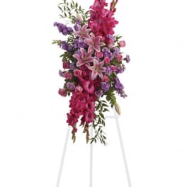 Tall pink and purple floral spray on a white stand