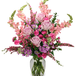 Pink and lavender flower arrangement in a glass vase