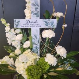 White floral cross with a memorial message for Dad