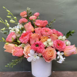 Pink and peach bouquet in a white vase