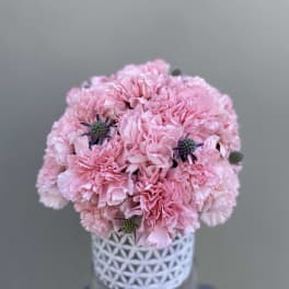 Pink carnation bouquet in a white patterned vase