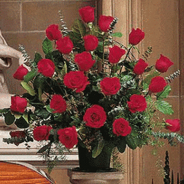 Tall fan-shaped arrangement of red roses in a black container
