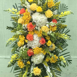 Standing floral spray with yellow, white, and orange blooms