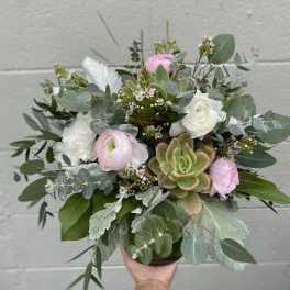 Handheld bouquet with pink and white flowers and succulents