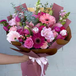Pink mixed bouquet with gerbera daisies, roses, tulips, and lilies