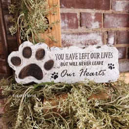 Memorial plaque with a paw print and sympathy message