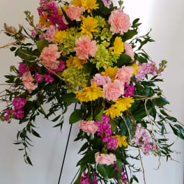 Standing floral spray with pink, yellow, and lavender blooms