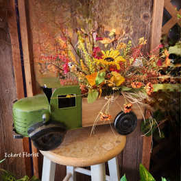Fall floral arrangement in a decorative truck container