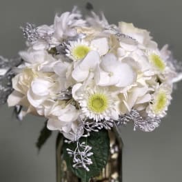 White hydrangea and daisy bouquet with silver accents in a vase