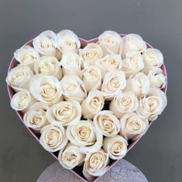 Heart-shaped box filled with cream roses