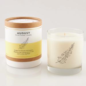 Two birth flower candles, one in a labeled box and one in a glass jar