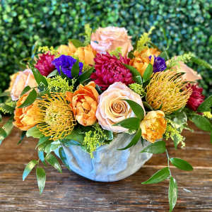 Colorful mixed bouquet in a pale blue vase