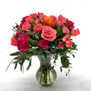Bouquet of pink and orange roses in a clear glass vase