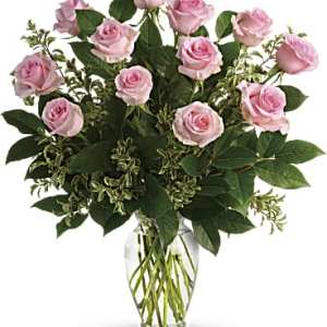 Pink roses arranged in a clear glass vase