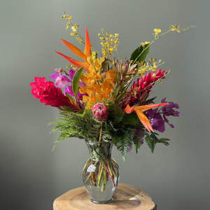 Bright tropical bouquet in a clear glass vase