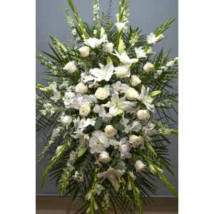 Tall white floral standing spray with roses, orchids, and lilies