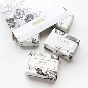 Four floral-patterned soap bars in white boxes on a white background