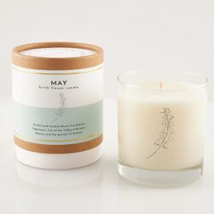 Two lily of the valley candles, one in a box and one in a glass jar