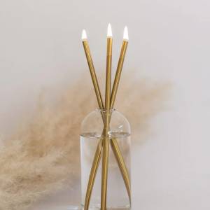 Clear glass vase with three gold reed diffusers