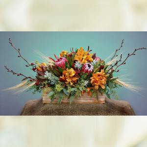 Mixed floral arrangement in a wooden box with orange and pink blooms