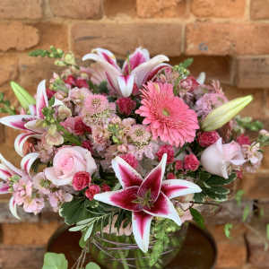 Pink and white mixed flower arrangement in a glass vase