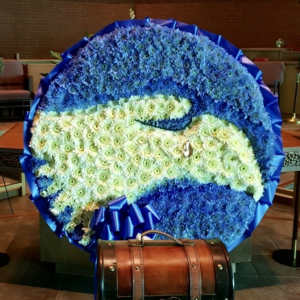 Large blue and white floral tribute with a ribbon border