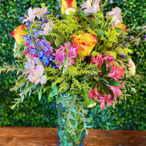 Colorful mixed bouquet in a blue glass vase