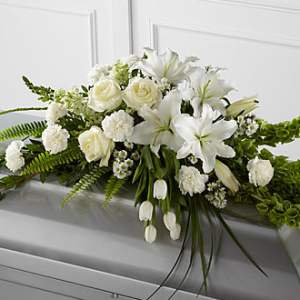 White floral casket spray with roses and lilies