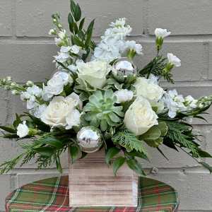 White roses and carnations in a wooden box with silver ornaments