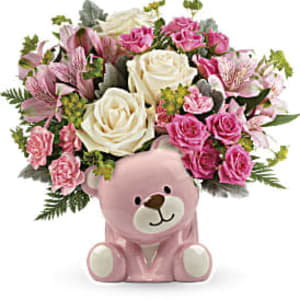 Pink ceramic bear vase filled with white roses and pink mixed flowers