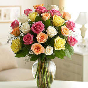 Bouquet of multicolored roses in a clear glass vase