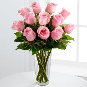 Pink roses arranged in a clear glass vase